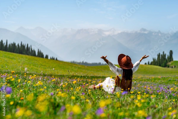Obraz Young woman traveler relaxing and enjoying beautiful Scenery landscape with colorful flowers in Kalajun grassland of Xinjiang in summer