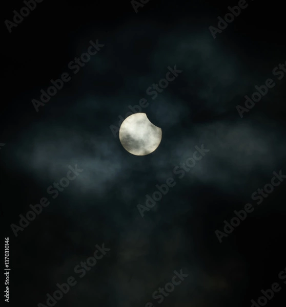 Obraz Solar eclipse through the clouds