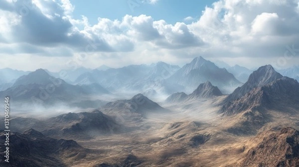 Fototapeta A vast, arid mountain range shrouded in a hazy, atmospheric mist, bathed in soft sunlight