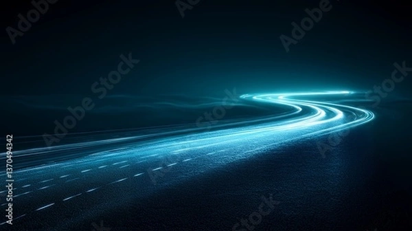 Fototapeta A winding road at night, illuminated by the bright streaks of headlights.  The dark landscape creates a sense of mystery and movement