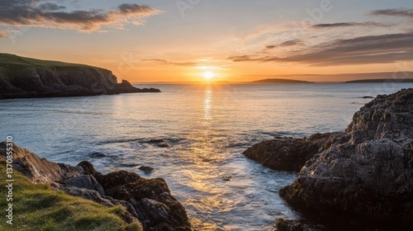 Obraz Coastal Sunset Panorama: A breathtaking coastal panorama unfolds, as the setting sun paints the sky with vibrant hues, casting a golden glow upon the tranquil water and rugged cliffs.