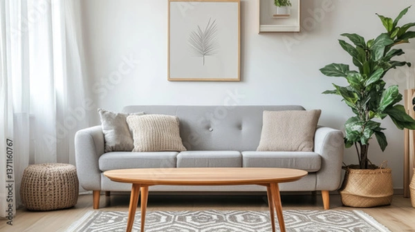 Obraz Stylish scandinavian interior of living room with design grey sofa, retro wooden table, mock up poster frame, decoration , carpet and personal accessories in elegant home decor.

