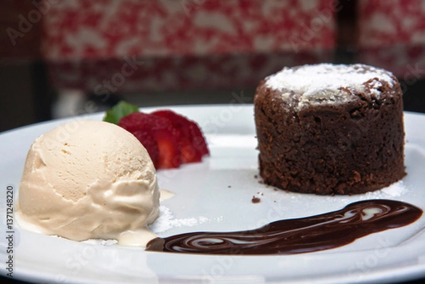 Fototapeta Delicious chocolate fondant with strawberry, chocolate sauce and walnut ice cream, desserts