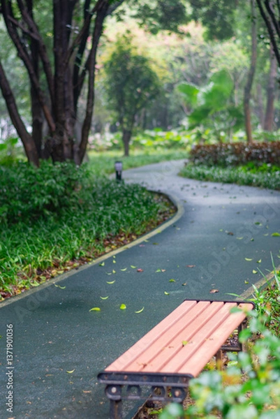 Fototapeta Whispering Woods Retreat: Sunlit Rustic Bench Along Curved Emerald Pathway – Nature's Perfect Sanctuary