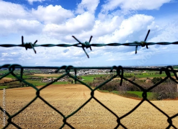 Fototapeta View from the top of a fence with a view of the countryside
