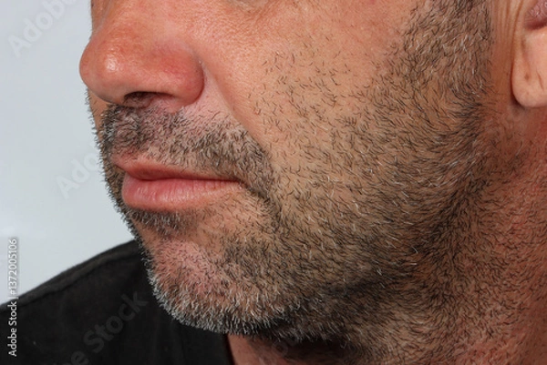 Obraz Lower face of a 45-year-old man with light stubble, showing natural facial texture