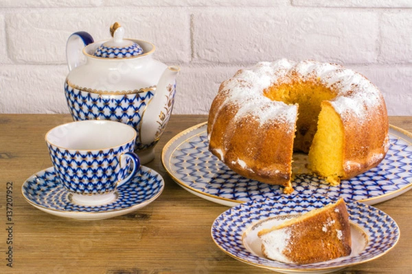 Obraz Exposition of apple pie cup of tea and kettle on wooden table and white brick background, Vintage Russian porcelain teacup and kettle.