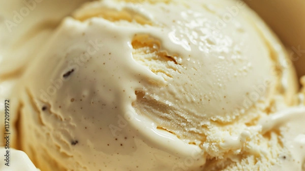 Fototapeta Close-up macro shot of a melting scoop of vanilla ice cream with visible vanilla bean specks