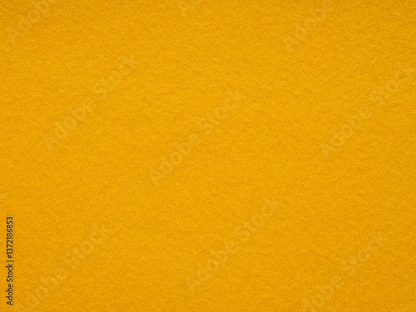 Fototapeta Mustard yellow felt texture emanates warmth and rustic charm, ideal for cozy and inviting design themes