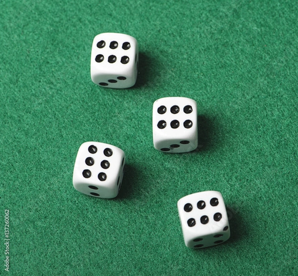 Fototapeta Four white dice with number six on green background. Horizontal shoot.