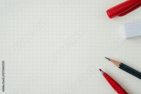 Fototapeta Top view, Close-up of Red Felt-tip Pen, Pencil and Eraser on Graph Paper Background, Copy Space for Text, Flat Lay Concept.