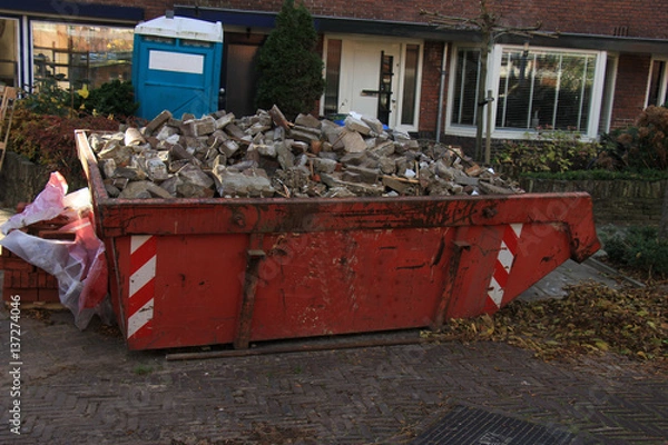 Fototapeta Loaded garbage dumpster