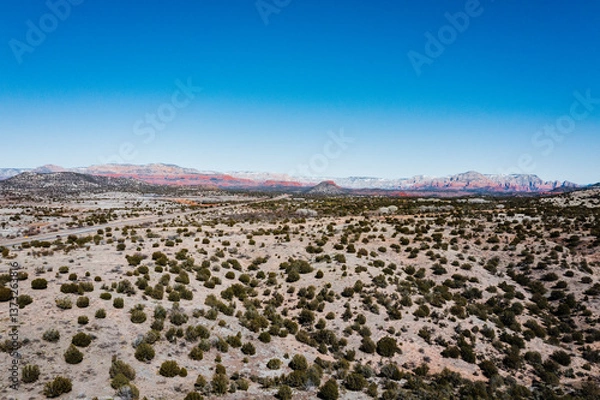 Obraz aerial view of desert landscape with red rock mountains in the background
