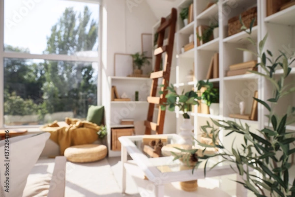 Fototapeta Shelving unit with books and coffee table in interior of living room. Blurred view