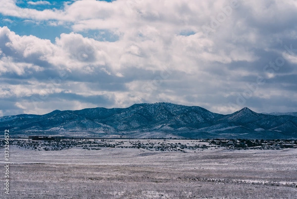 Fototapeta snowy desert and mountain landscape with cloudy sky