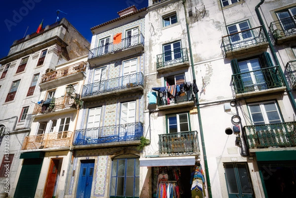 Fototapeta urban living in a historic environment in an authentic southern setting in the old town of lisbon