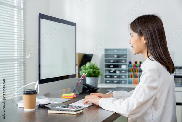 Fototapeta Business woman hand using computer and type on the keyboard. Mockup screen of advertisement.