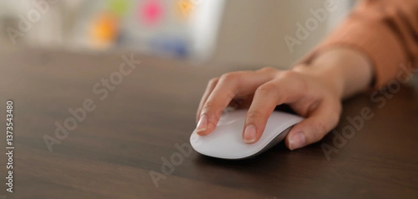 Fototapeta Close up of hand press the button computer mouse on table.