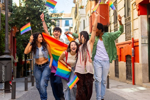 Obraz Young activists celebrating with rainbow flags at pride parade