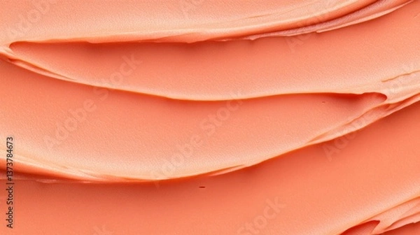 Fototapeta Soft coral cream is applied in layered strokes, creating a smooth and visually appealing texture. The vibrant color adds depth, perfect for art or makeup