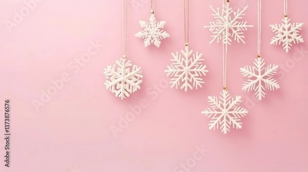 Fototapeta Delicate snowflakes on a soft pink canvas: a gentle winter's whisper.