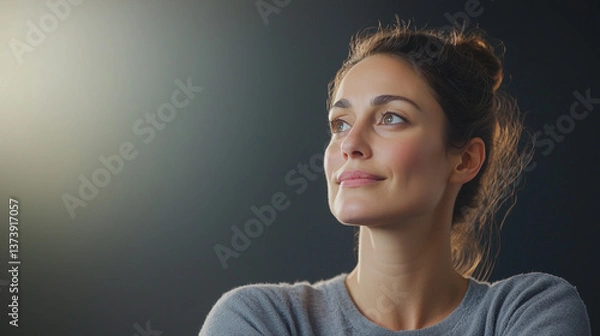 Obraz Poised for the Future: A portrait of a determined young woman radiates confidence, bathed in a soft, ethereal light, her gaze set on the horizon, full of hope.