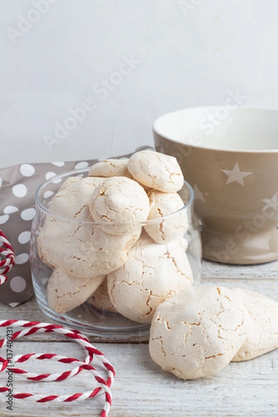 Fototapeta meringue in a glass jar, tea cup on a white background