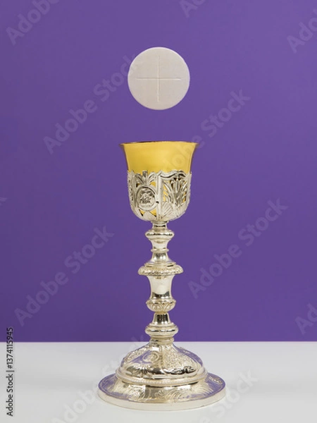 Obraz Silver chalice and white communion wafer