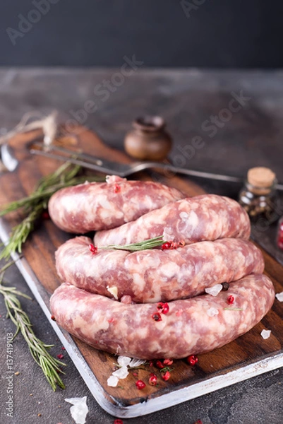 Fototapeta Raw sausages with spice