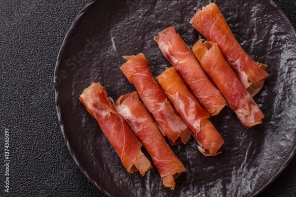 Fototapeta Cheese and meat, jamon or prosciutto rolled into a roll