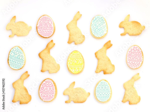 Fototapeta Pattern with homemade Easter cookies on white background. Top view, Easter card.