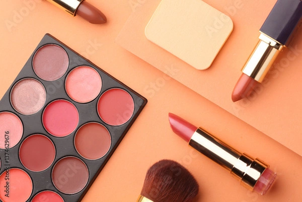 Fototapeta Minimal modern cosmetic scene with make up brushes, eye shadows palette, lipstick, powder and shadow overlay, color of the year 2025 mocha mousse