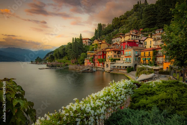Fototapeta Varenna village. Beautiful sunset with clouds in Alps mountains. Epic blue lake near Milan, mountain, villa, forest, colorful flowers. Premium landscape from pure nature, Lombardy, Italy