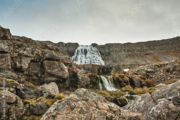 Fototapeta Dynjandi waterfall cascading through rugged cliffs in Westfjords, Iceland...