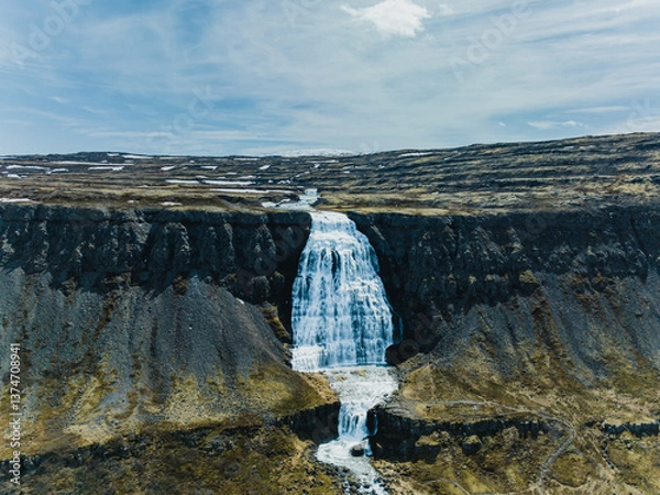 Fototapeta Dynjandi waterfall cascading through rugged cliffs in Westfjords, Iceland..