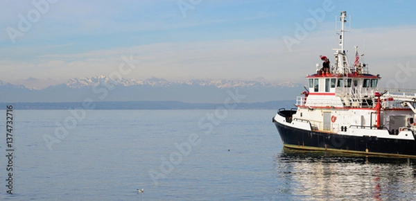 Obraz A firefighting boat in the Seattle harbor at Puget Sound with the Olympic mountains in background