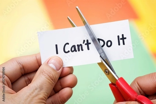 Obraz Scissors slice through a paper that expresses a challenging sentiment, symbolizing the act of overcoming barriers in a colorful, cheerful environment.