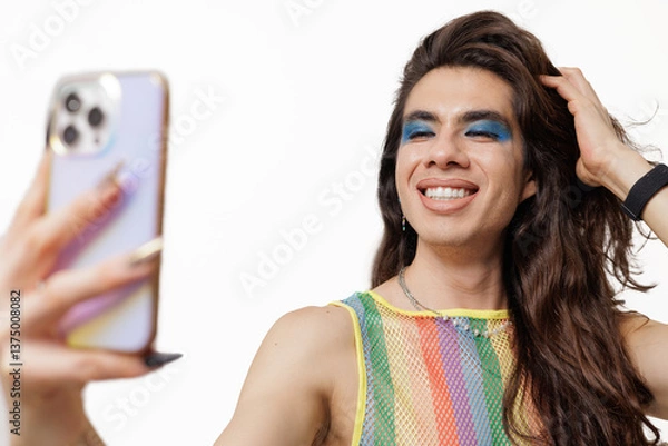 Obraz Genderqueer person takes a selfie wearing pride clothing, smiling and posing happily for the camera.