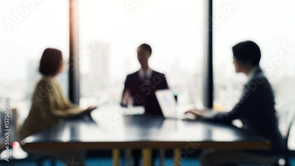 Fototapeta Blurred image of a group of business people having a meeting in an office