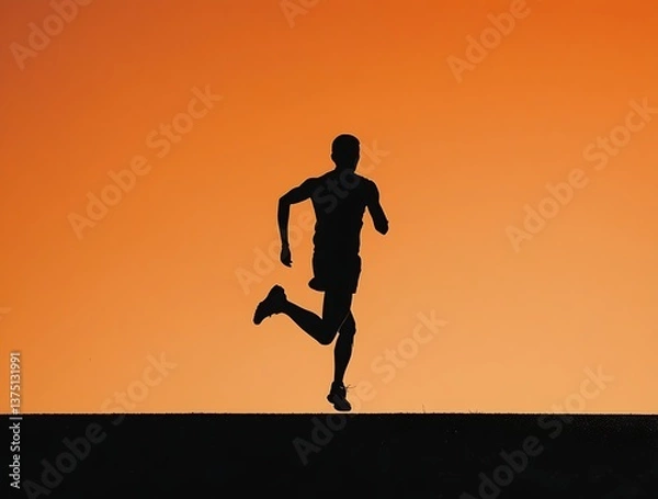 Obraz Dynamic image of a person running at dusk, captured in motion with a powerful sunset backdrop, representing speed, strength, perseverance, and sports inspiration

