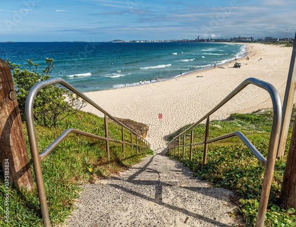 Fototapeta A view of City Beach in Wollongong, New South Wales, Australia while lifeguards patrol to keep swimmers safe