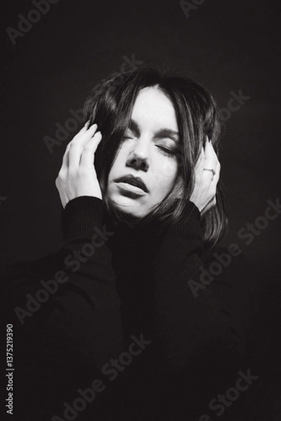 Obraz Portrait of a woman with dark hair, done in low key style.