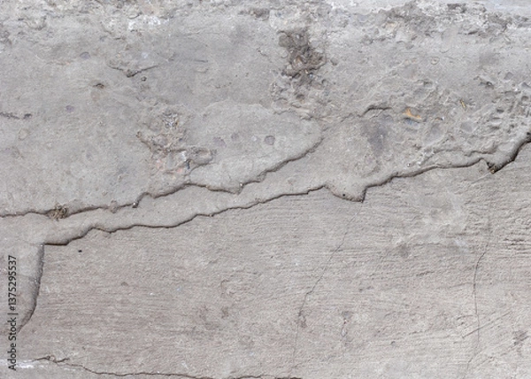 Fototapeta Background of destroyed concrete path, gray concrete, concrete texture, close-up. Natural photo. Old concrete slab