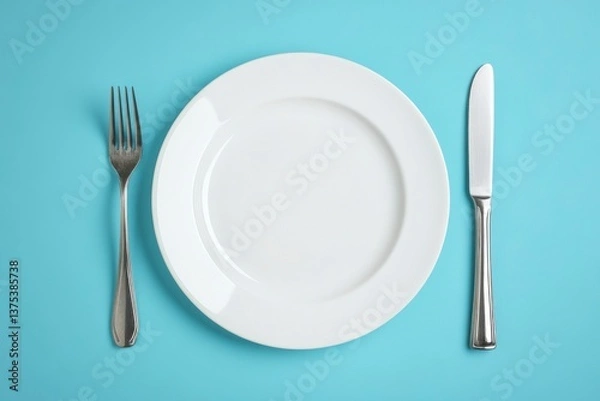 Obraz Empty White Plate with Fork and Knife on Light Blue Background