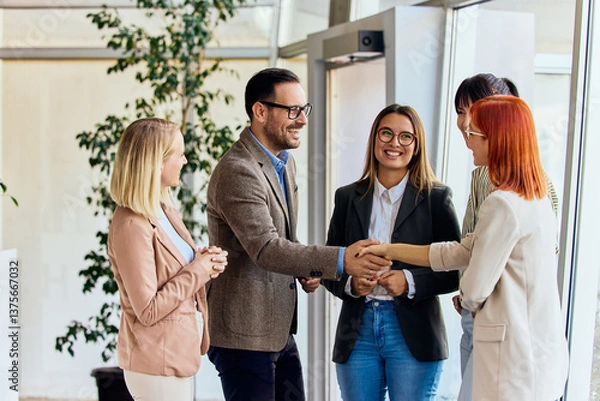 Fototapeta Professional Business Team Shaking Hands During a Friendly Office Meeting