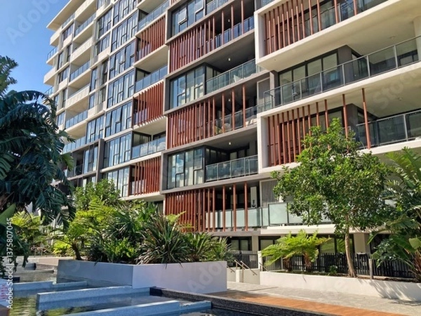 Fototapeta Modern apartment block with courtyard in foreground