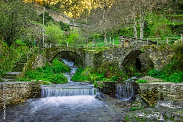 Obraz Mountain waterfall in the iconic ancient portuguese stone village of Piodao