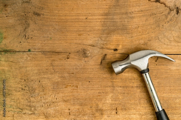 Fototapeta Iron hammer on wooden desk