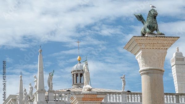 Fototapeta Panoramic view over San Marco square roof top towers, sculptures and the symbol of Venice a winged lion at Doge Palace, Venice, Italy, summer time, closeup, details