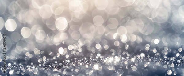 Fototapeta An elegant silver and white bokeh background with a soft and shimmering sparkle.